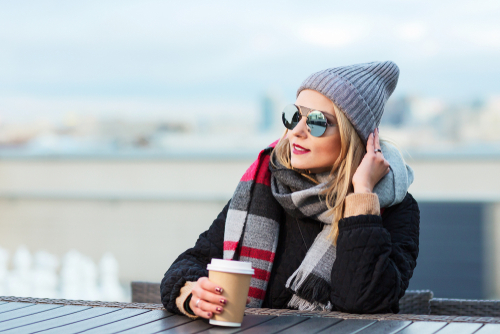 A woman with a coffee sitting outside