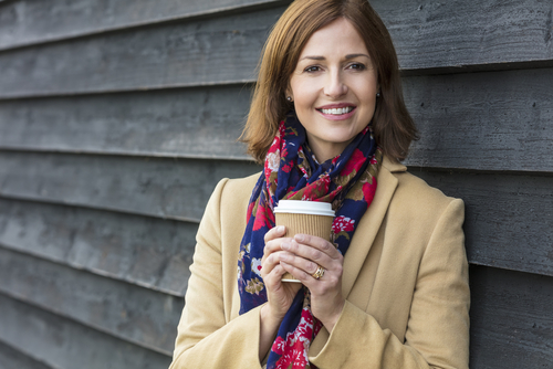 woman holding cup of coffee