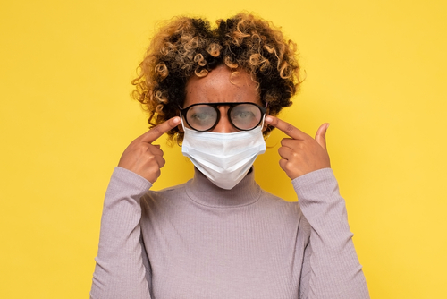 Woman with mask and foggy glasses