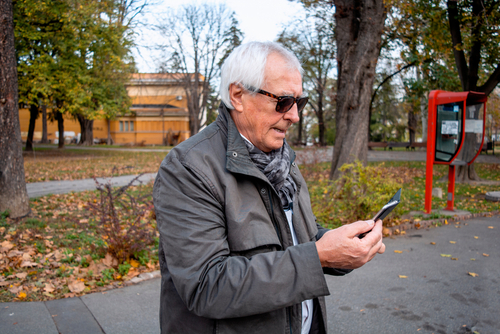 Senior man looking at phone